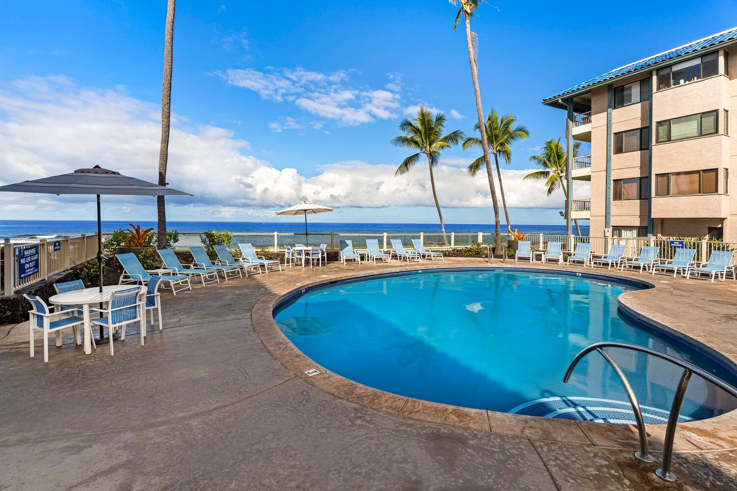 Kailua Kona Vacation Rentals, Kona Reef F11 - Enjoy the poolside chaise loungers to relax under the sun.