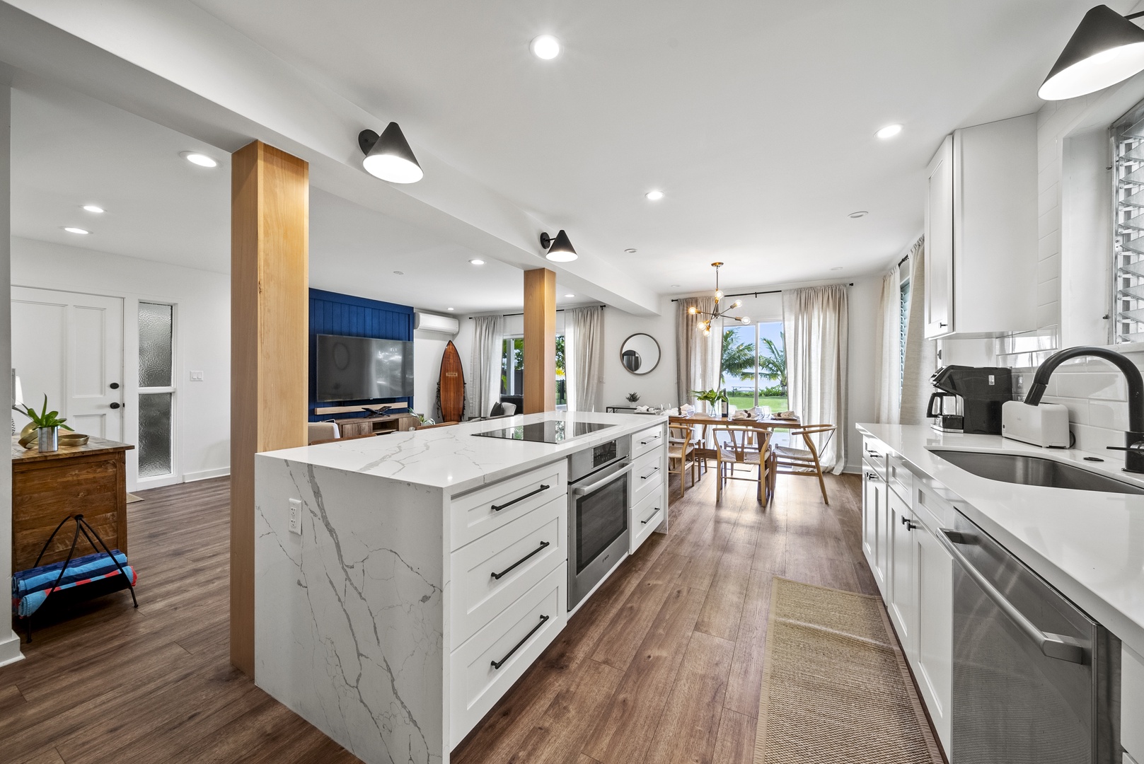 Honolulu Vacation Rentals, Honolulu Beachfront Retreat - Contemporary kitchen featuring marble countertops, premium appliances, and bar seating — inspiring culinary creations for your stay.