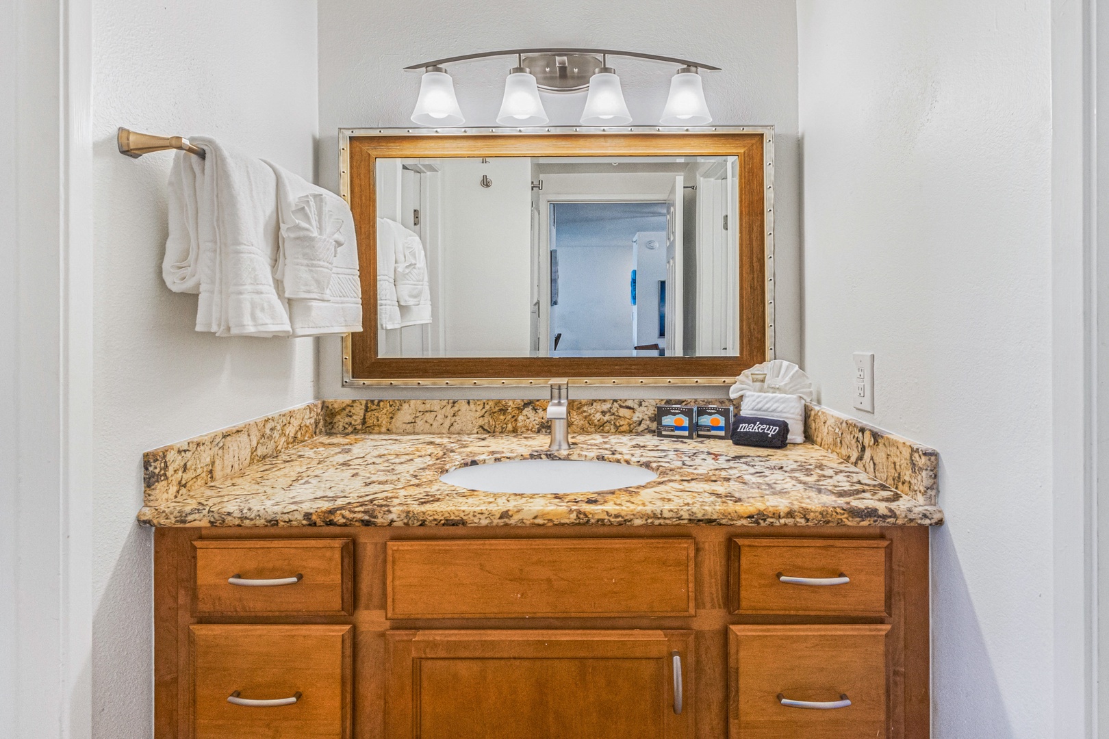 Lahaina Vacation Rentals, Royal Kahana 213 - The bathroom features a granite countertop and well-lit vanity, providing a clean and comfortable space to refresh during your stay.