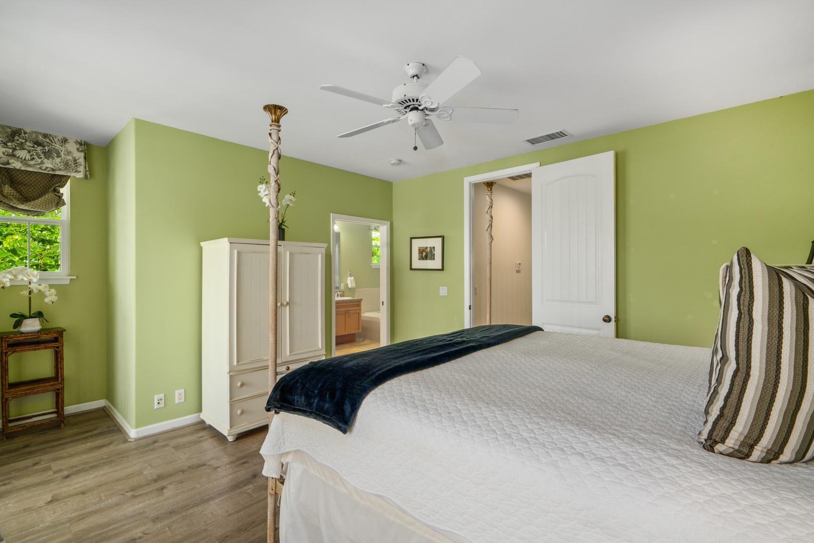 Princeville Vacation Rentals, Kaimana Villa - Rest peacefully in your cheerful green retreat with plush bedding, ceiling fan, and charming wardrobe storage.