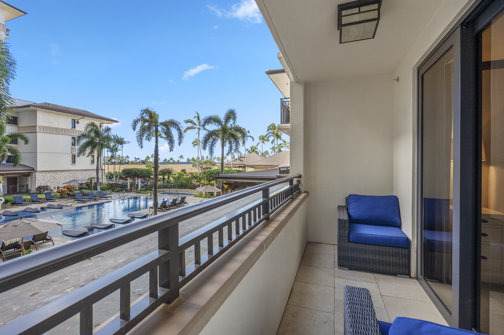 Look down from the lanai and the resort pool sits right below, palms all around.