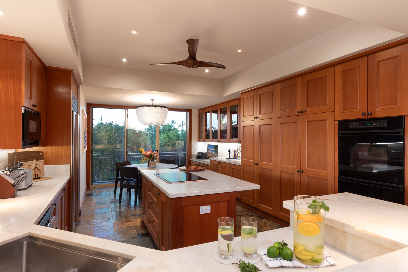 Kailua Kona Vacation Rentals, 3BD Waiulu Villa (111D) at Hualalai Resort - Contemporary kitchen featuring bar seating for three, perfect for casual dining.