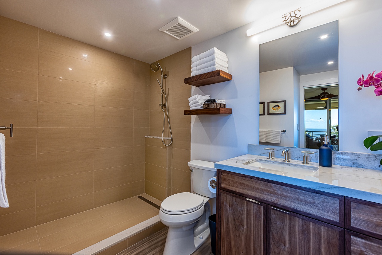 Kihei Vacation Rentals, Kamaole Beach Royal 610 - The primary bath's mirror catches the ocean view waiting just outside the slider.