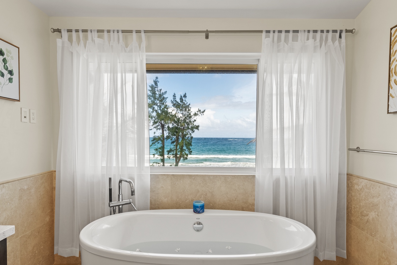 Laie Vacation Rentals, Laie Beachfront Estate - Soak in the tub while enjoying the stunning ocean view through the large window.