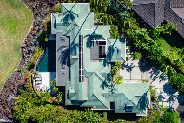 Kamuela Vacation Rentals, Canoe House & Beach Walker at Champion Ridge - Aerial view of a spacious tropical home with a private pool, surrounded by lush landscaping.