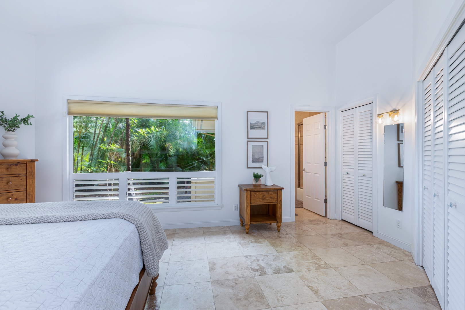 Princeville Vacation Rentals, Ohana Kamalani - King bedroom with garden views, ceiling fan, and clean design for a peaceful night’s sleep.