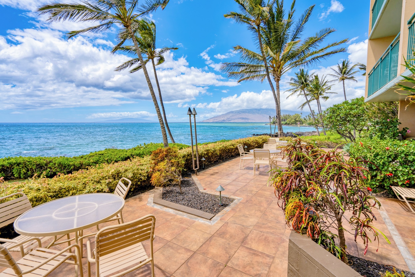 Kihei Vacation Rentals, Punahoa Beach 205 - Stroll the palm-lined walkway along the water, with mountains rising across the ocean in the distance.