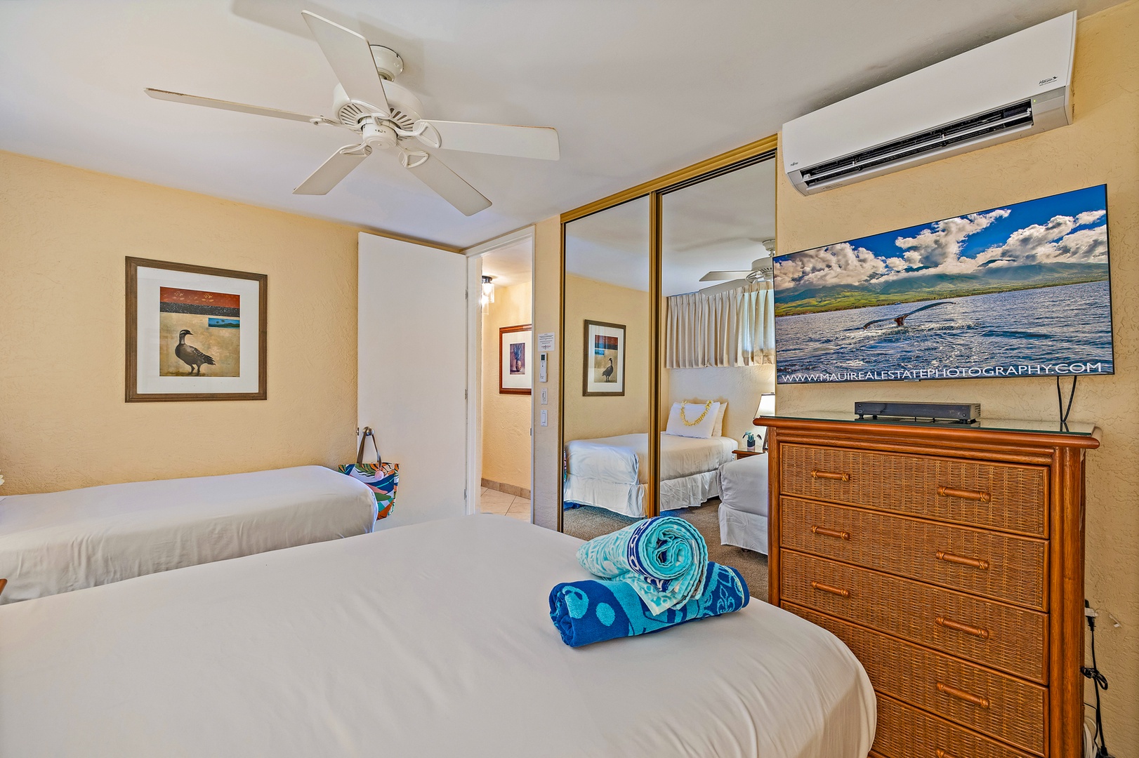 Lahaina Vacation Rentals, Papakea G-306 - The guest bedroom includes ample storage space with a large mirrored closet and a TV, offering comfort and convenience for a relaxing stay.