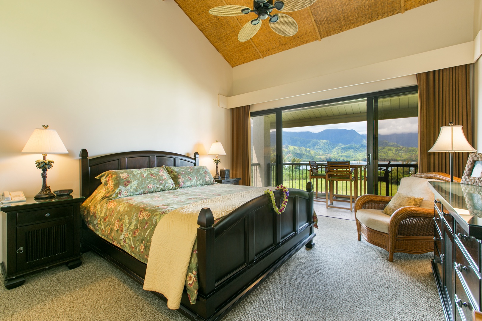 Princeville Vacation Rentals, Hanalei Bay Resort 4301/2/3 - Spacious bedroom with a king-sized bed, elegant furnishings, and access to a private lanai offering breathtaking mountain views.