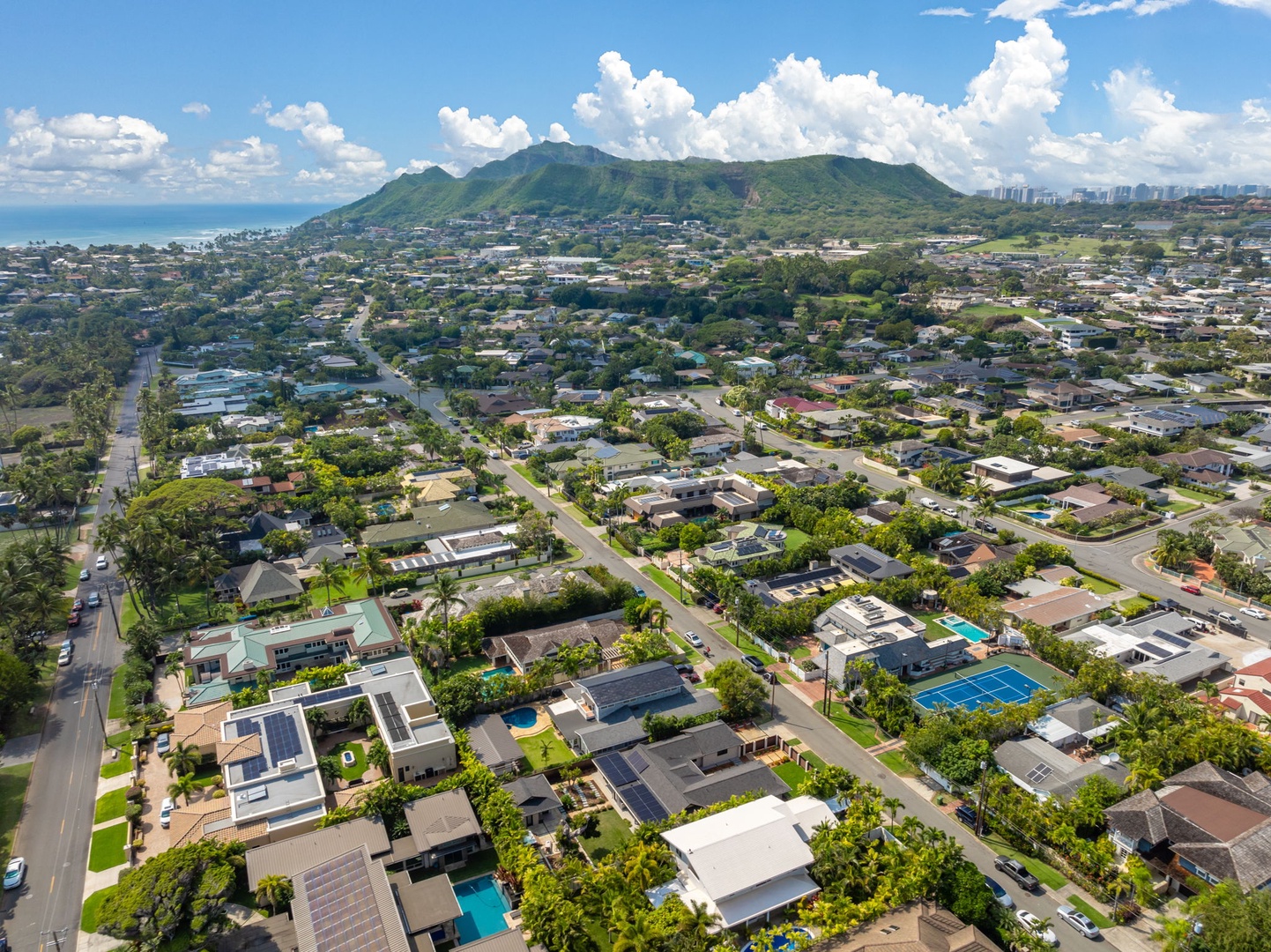 Honolulu Vacation Rentals, Kahala Zen - Aerial view of a vibrant neighborhood nestled against scenic mountain landscapes.