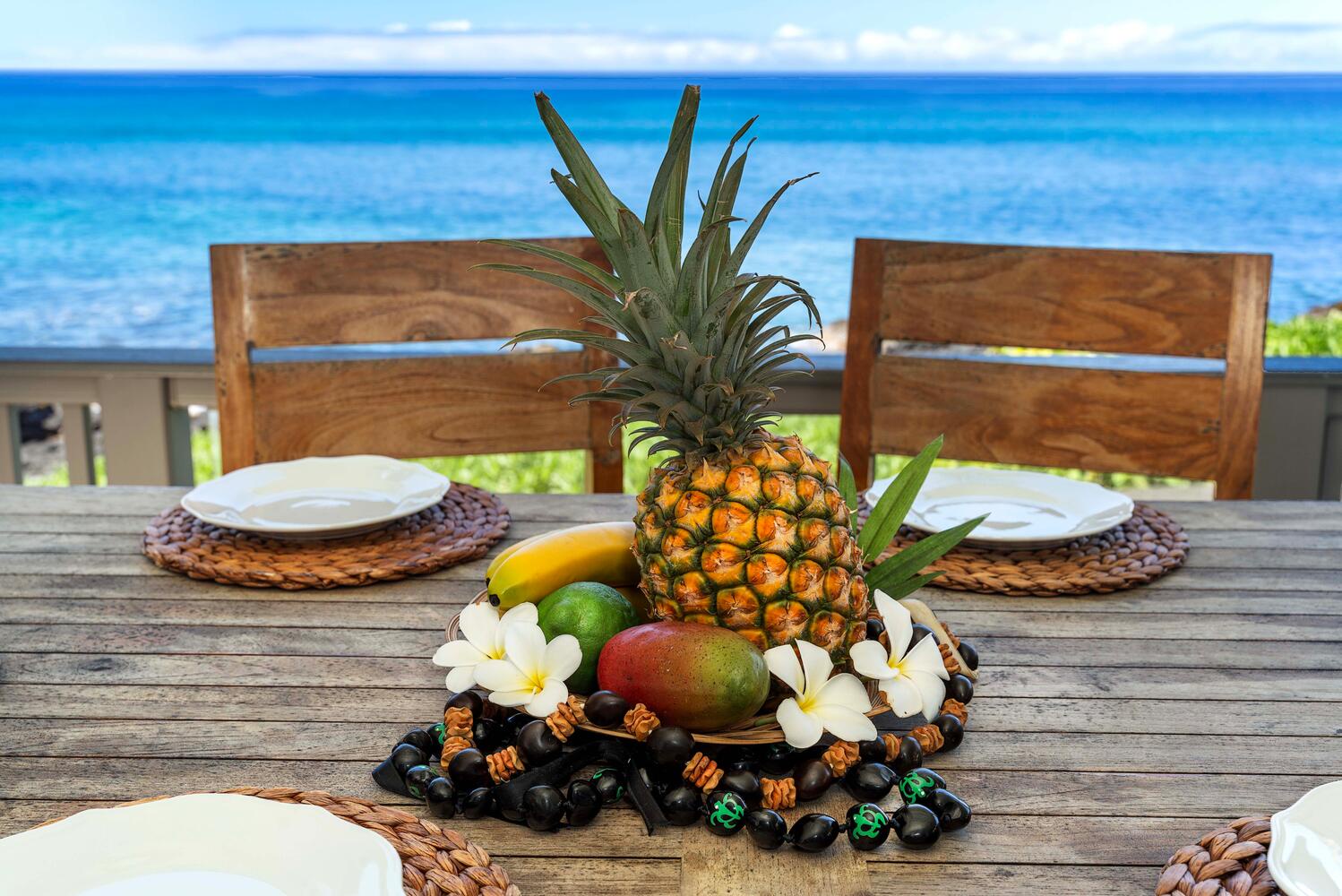Kailua Kona Vacation Rentals, Hale Kai O'Kona #7 - Tropical fruit centerpiece on the lanai dining table with ocean backdrop.