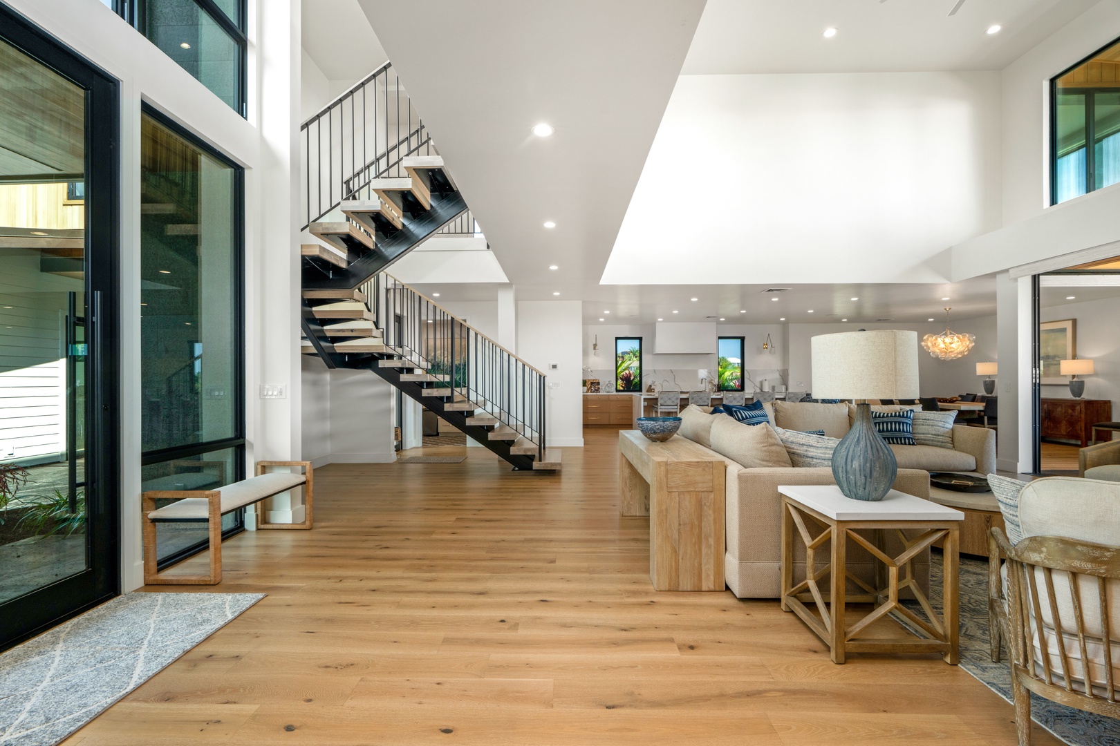 Koloa Vacation Rentals, Hale Laule'a at Kukui'ula - The spacious open-plan living area has soaring ceilings, warm wood floors, and designer furnishings that create the perfect atmosphere for memorable moments.