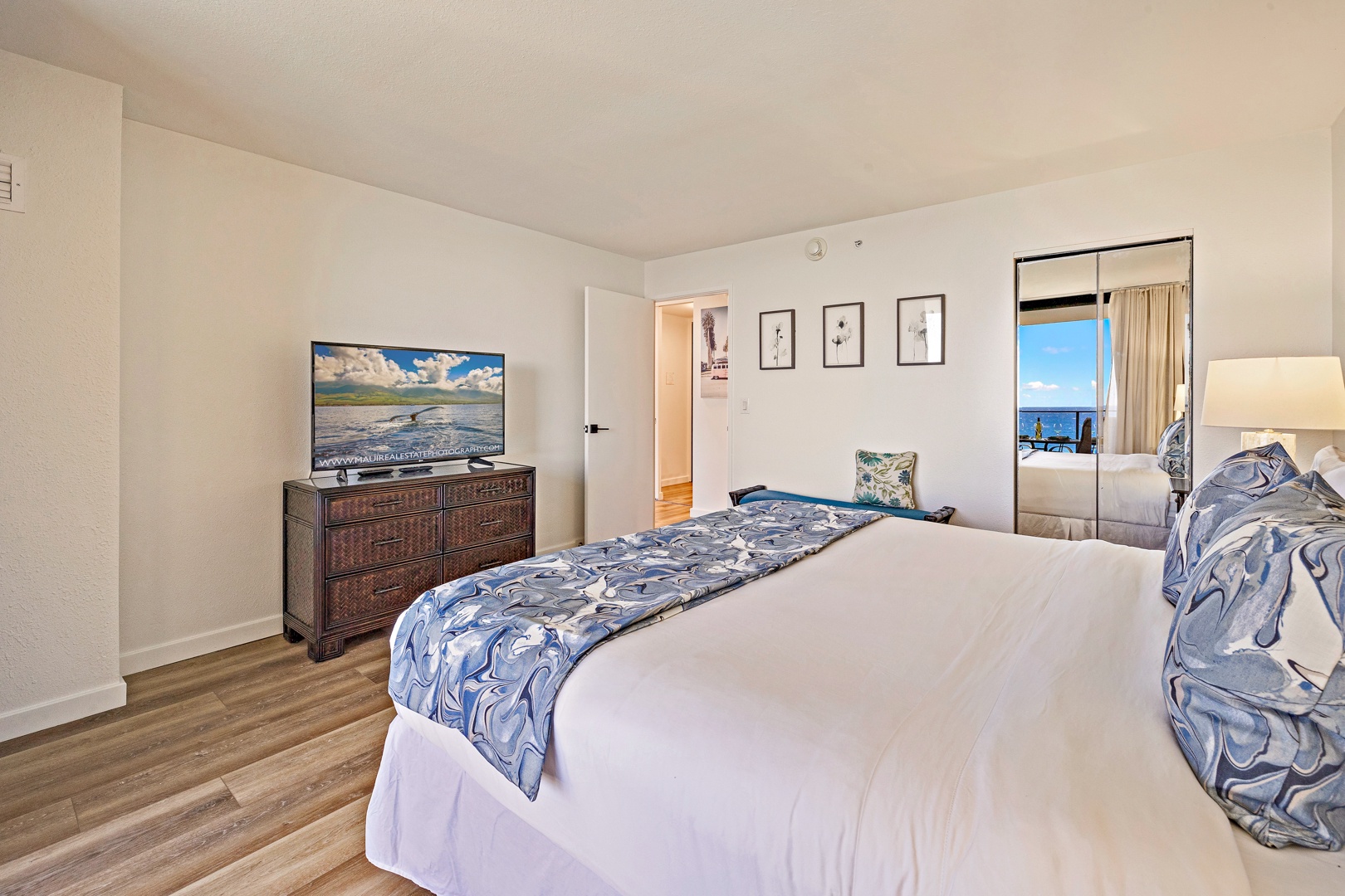 Lahaina Vacation Rentals, Mahana 718 - The bedroom offers a serene retreat with a comfortable bed, flat-screen TV, and a view of the ocean just beyond the sliding glass doors.