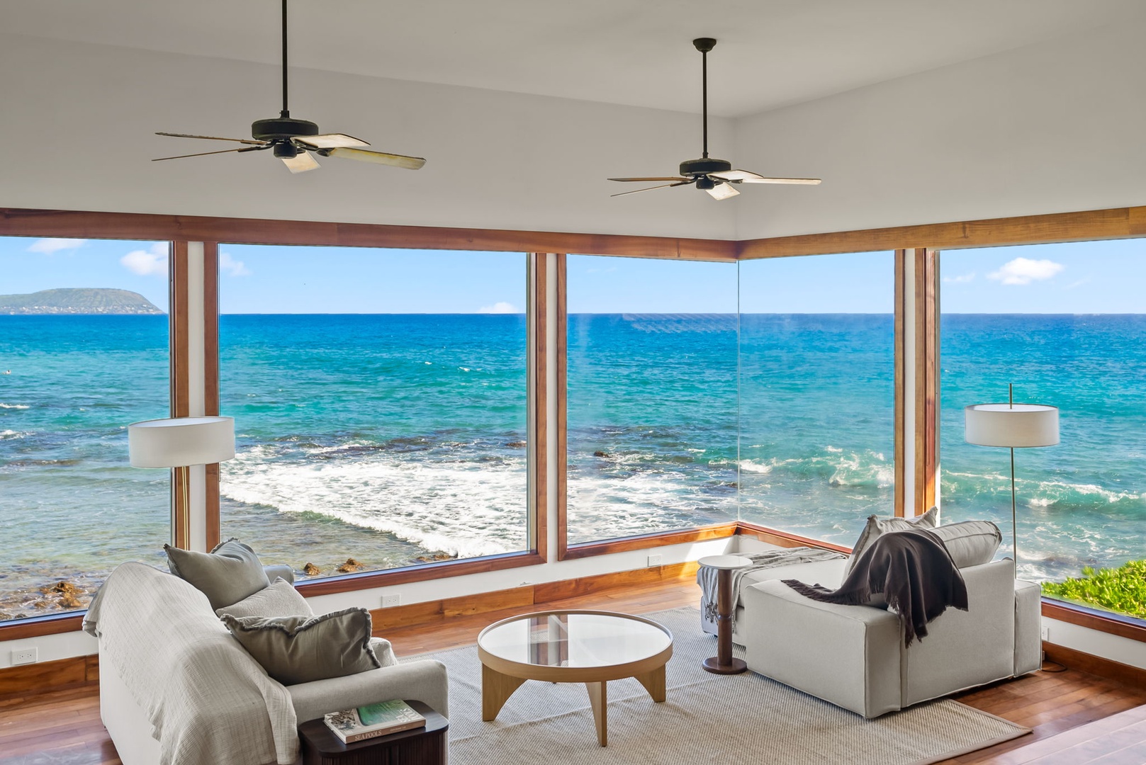 Honolulu Vacation Rentals, Black Point Ocean Villa - Watch waves crash from your private oceanfront living room, where floor-to-ceiling windows frame endless turquoise waters and comfortable seating awaits.