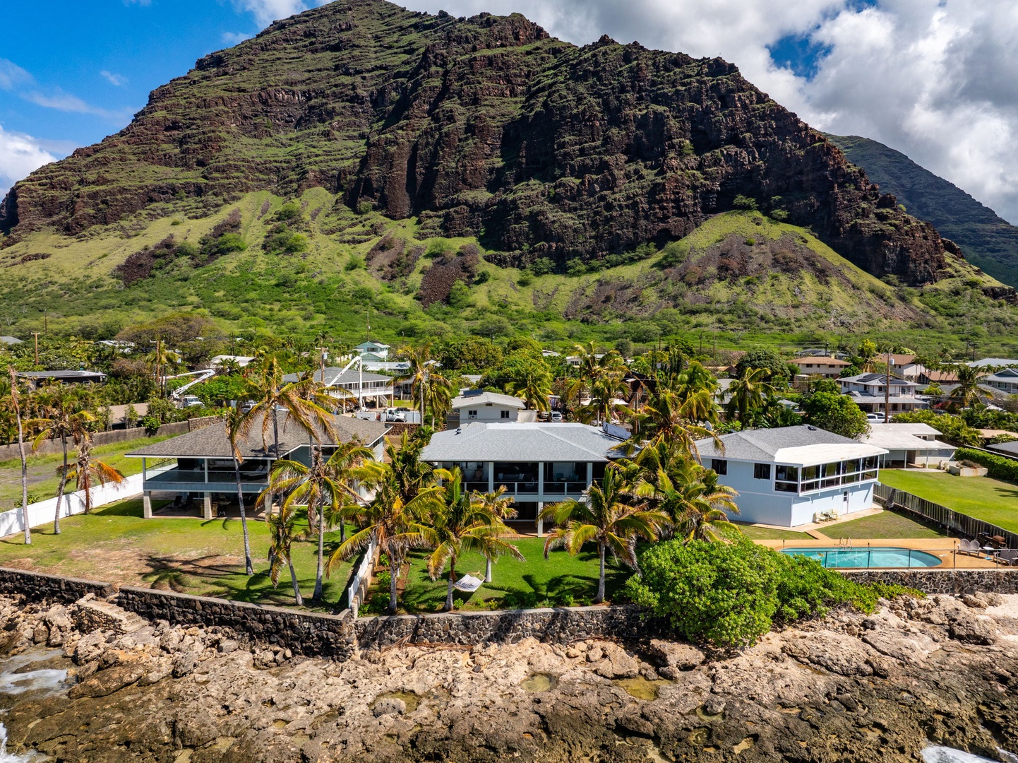 Waianae Vacation Rentals, Oceanfront Luxury Dream Estate - A lush mountainside backdrop meets modern coastal architecture in this view from behind the estate.