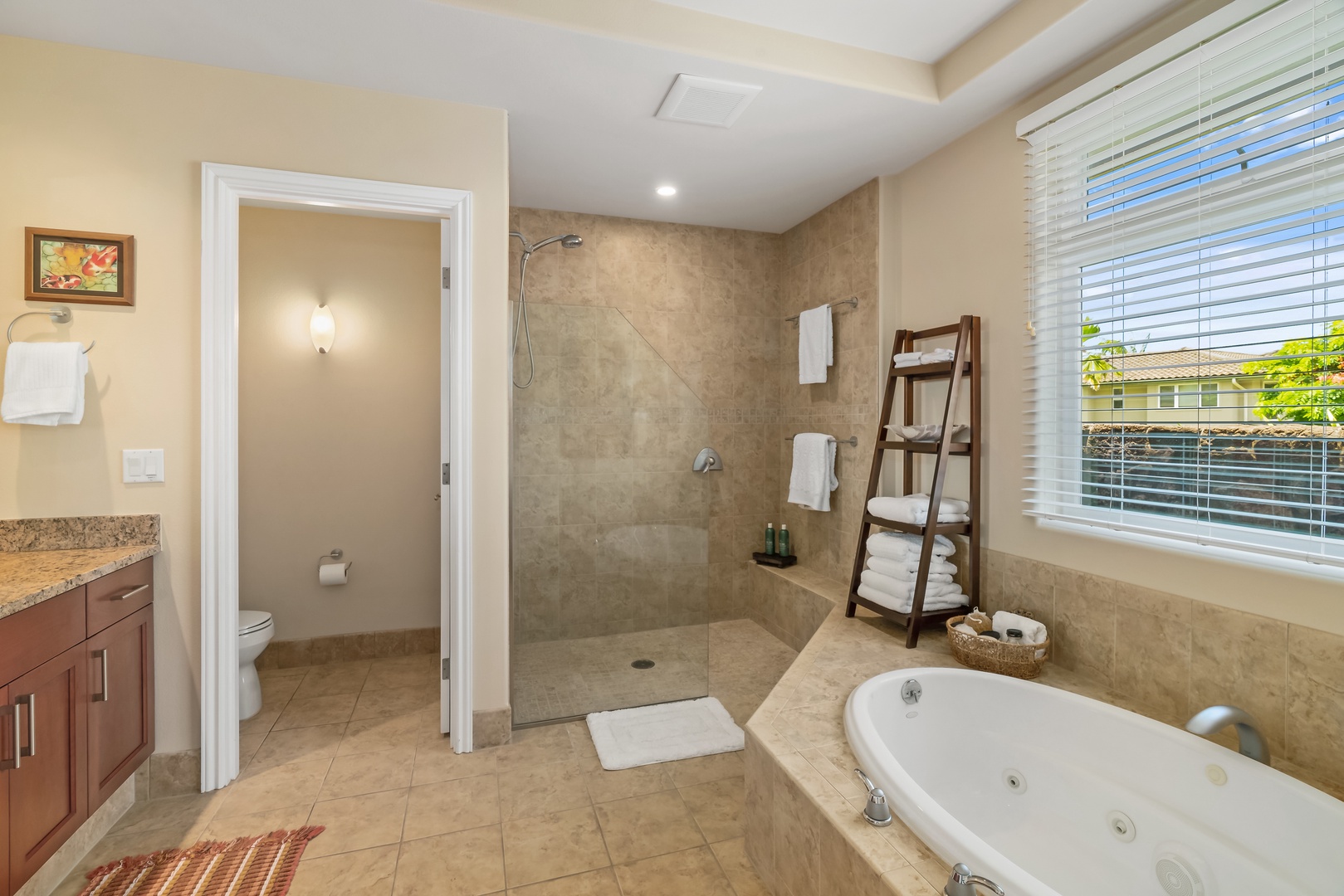 Princeville Vacation Rentals, Noelani Kai - The ensuite bath tempts with an oversized soaking tub, promising indulgent moments of relaxation.