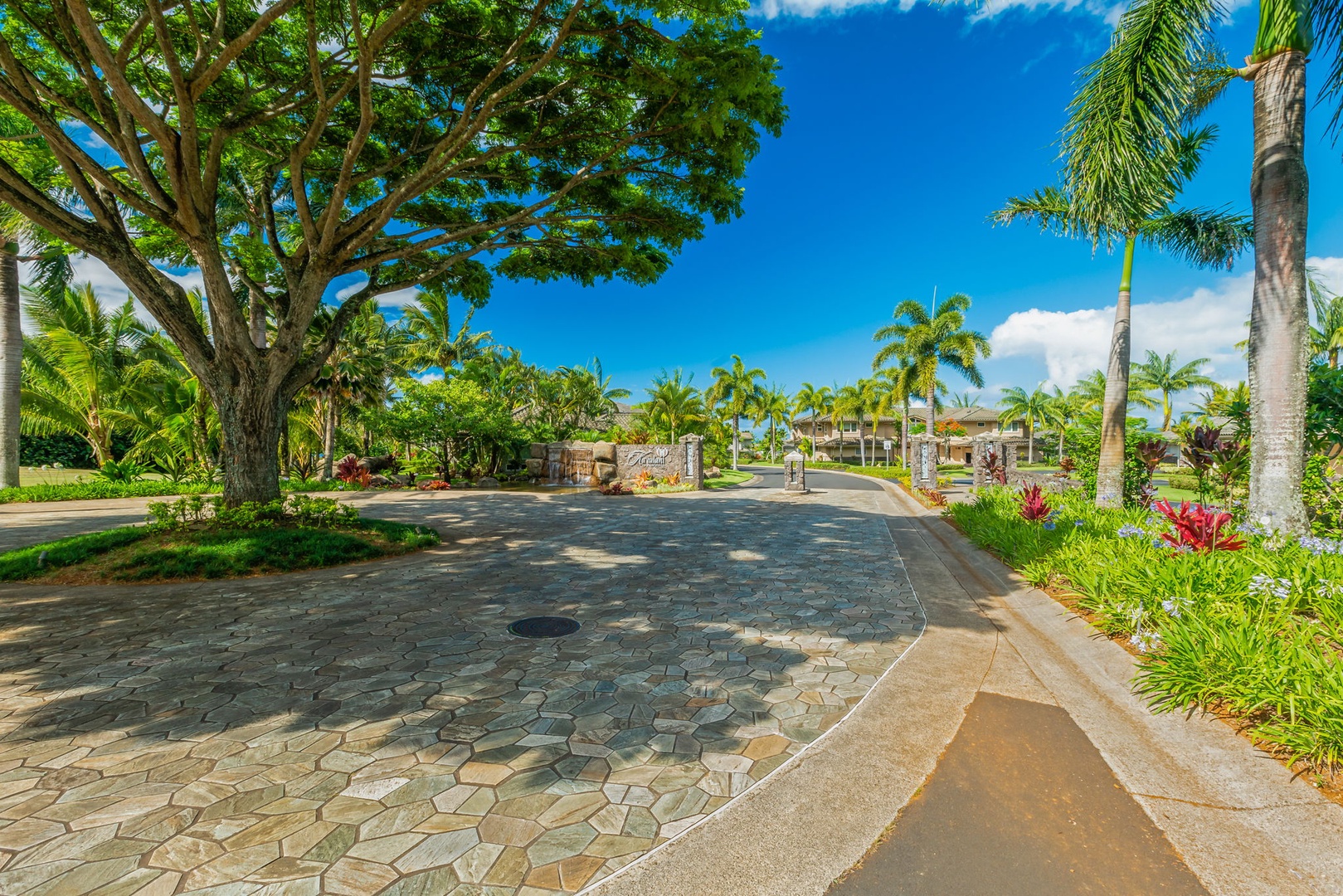 Princeville Vacation Rentals, Kaiulani #8 - Walk the stone path under the wide canopy of a big shade tree.