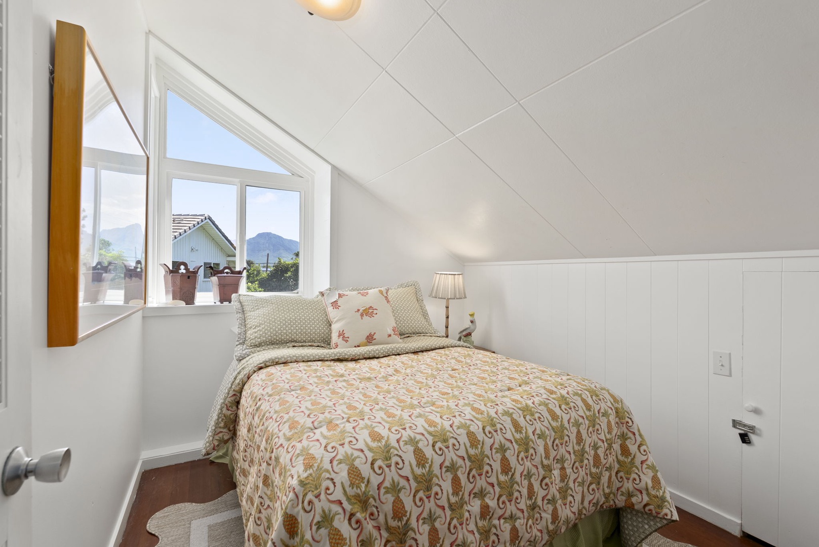 Waianae Vacation Rentals, Ma'ili Blue Estate - Your cozy bedroom has mountain views through charming windows and soft, patterned linens.