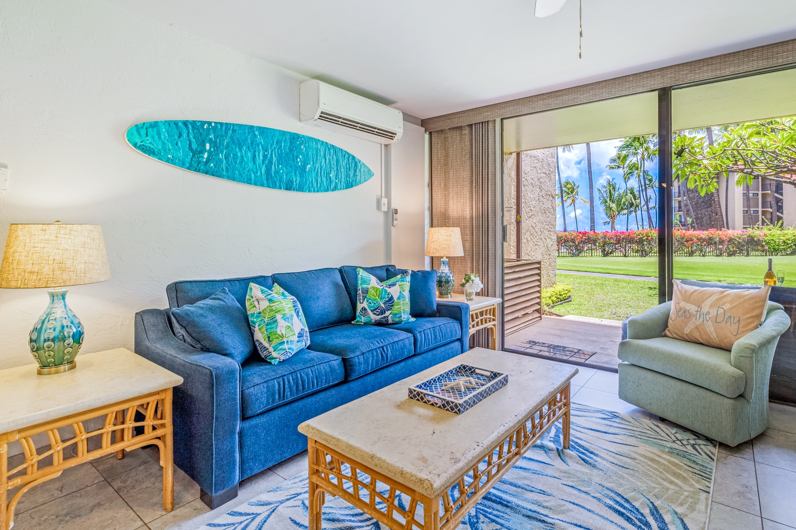 Lahaina Vacation Rentals, Papakea K-105 - The cozy living area offers comfortable seating with direct access to the lanai, perfect for relaxing while enjoying views of the garden and ocean.