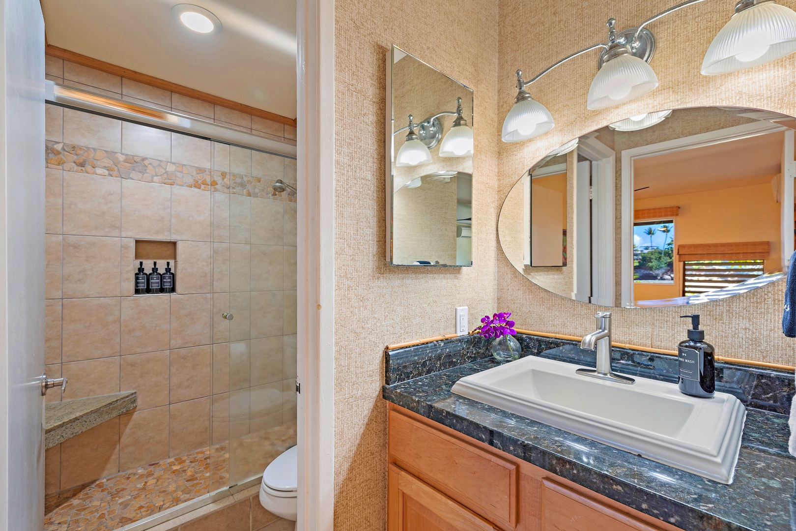 Lahaina Vacation Rentals, Kahana Sunset B4B - The bathroom offers a modern design with a granite countertop, a well-lit vanity, and a spacious walk-in shower, providing both comfort and style.