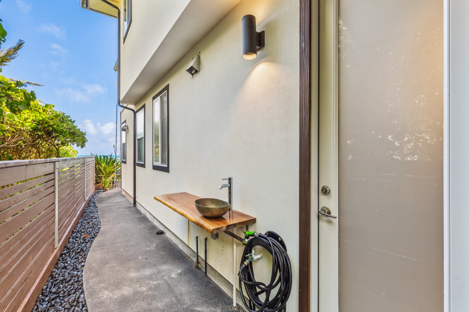 Laie Vacation Rentals, Majestic Mahakea Oceanfront Oasis - Outdoor pathway with soft lighting and clean modern design leading to the entrance.