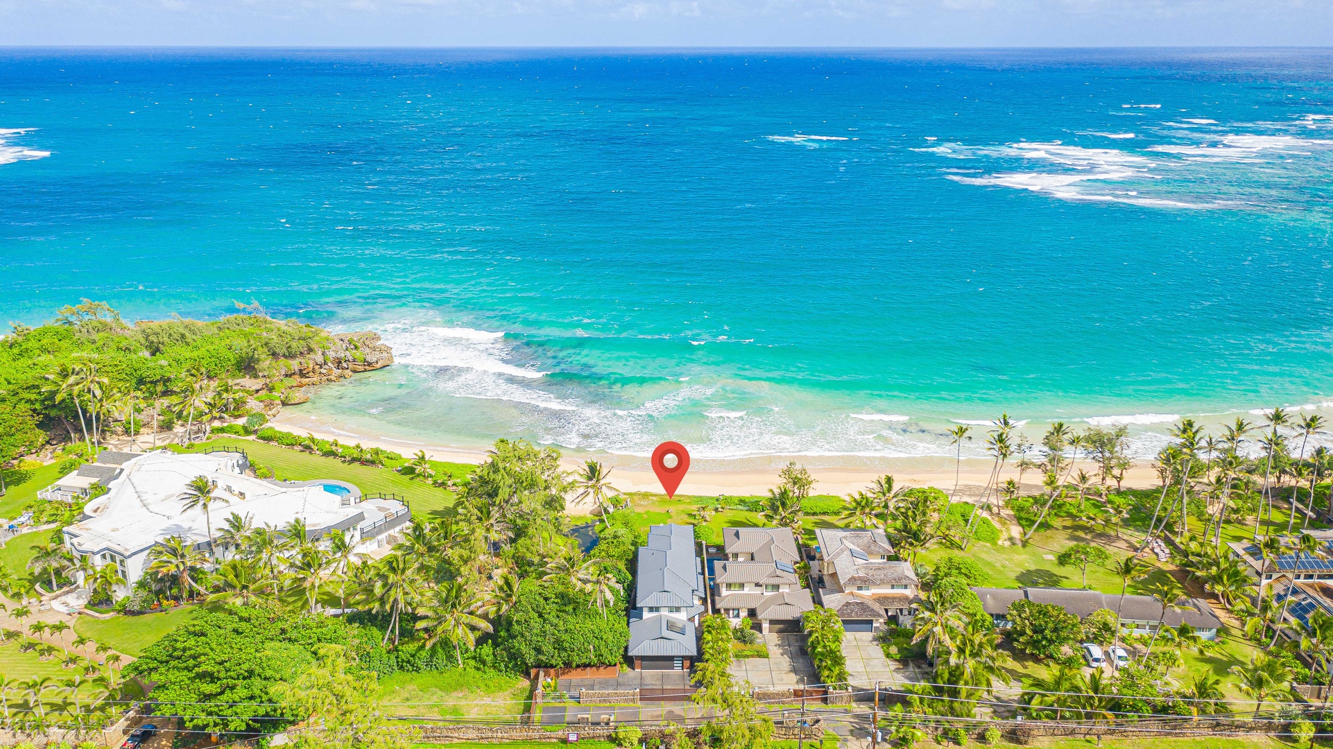 Laie Vacation Rentals, Majestic Mahakea Oceanfront Oasis - Aerial perspective highlighting the home's proximity to the beach and crystal-clear waters.