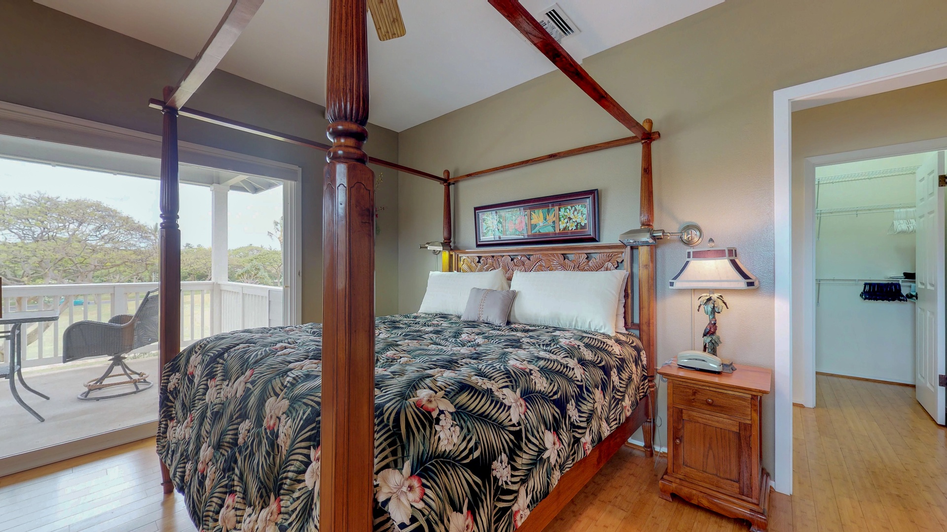 Kapolei Vacation Rentals, Coconut Plantation 1080-1 - The upstairs primary guest bedroom with Polynesian style furnishings and access to the lanai.