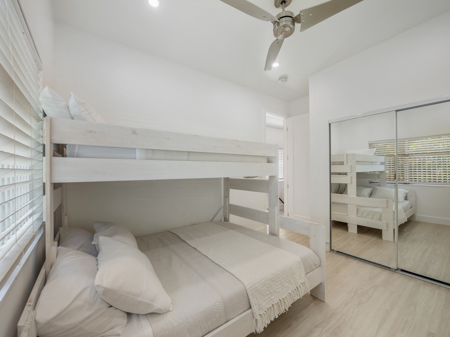 Haleiwa Vacation Rentals, Sunset Beach Island Retreat - The secondary bedroom is ideal for families or groups, featuring a bunk bed with a full-size lower bed and a twin on top.