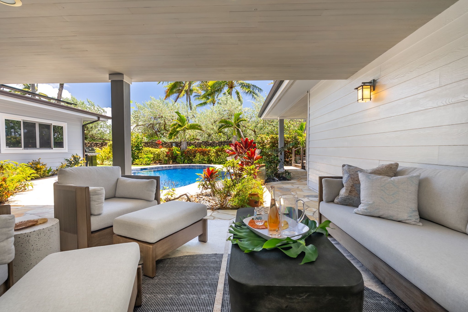 Kailua Vacation Rentals, Kailua Beach House - Cozy spot to sit back, relax, and enjoy views of the pool and tropical garden.