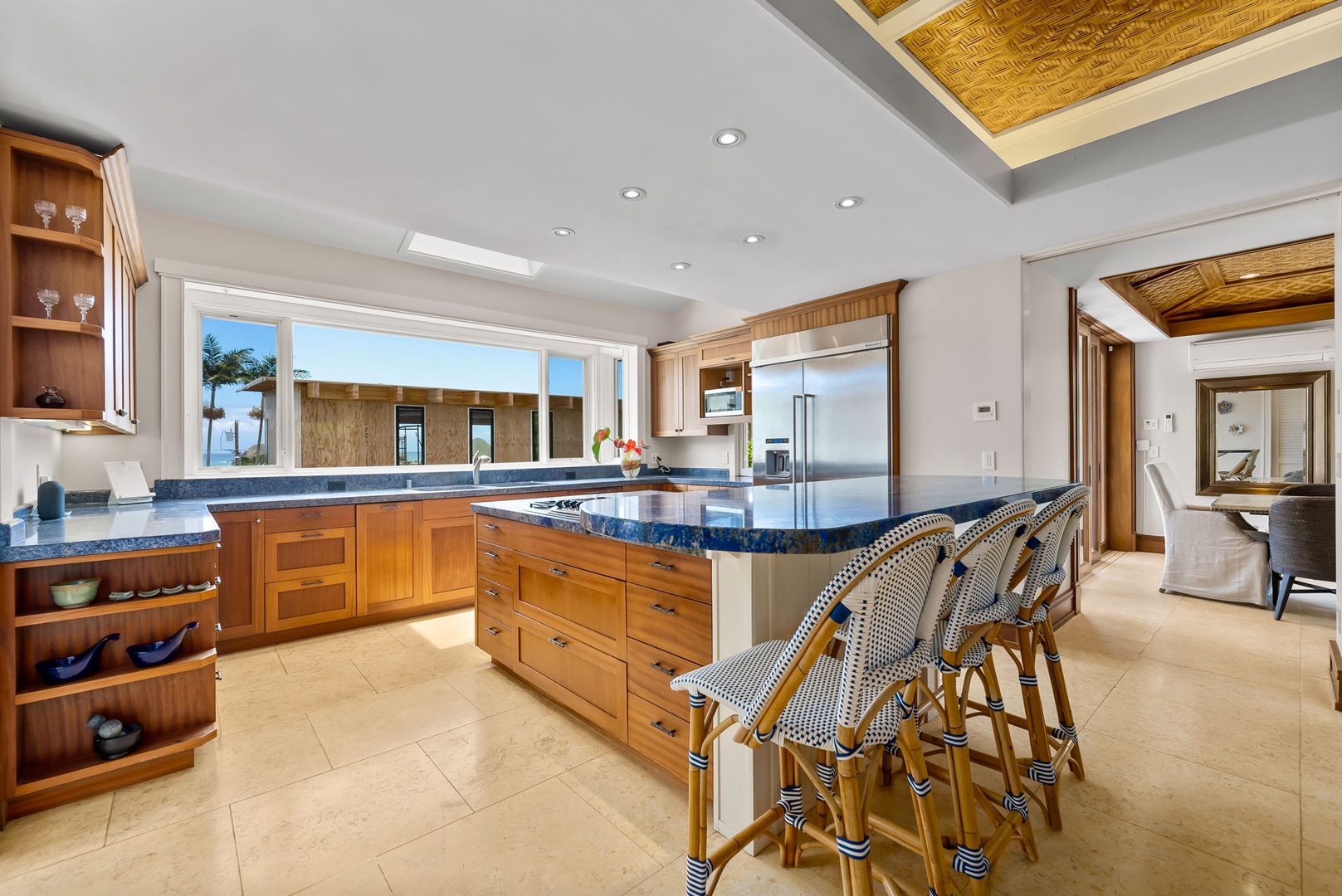 Kailua Vacation Rentals, Leaf House - Gather around this spacious kitchen with a large island, perfect for preparing meals or casual dining. Natural light pours in through expansive windows, while beautiful wood cabinetry adds warmth and charm.