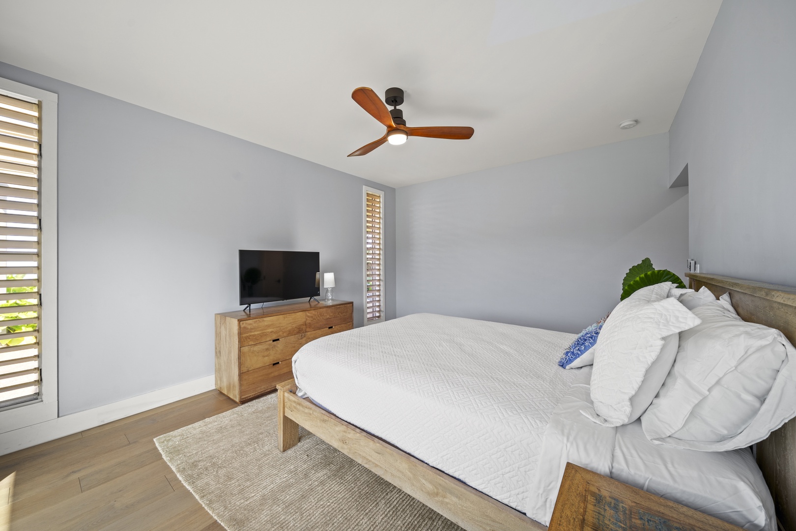 Haleiwa Vacation Rentals, Hale Mahina - Settle in for the evening with a comfortable bedroom, Smart TV, and soft natural light.