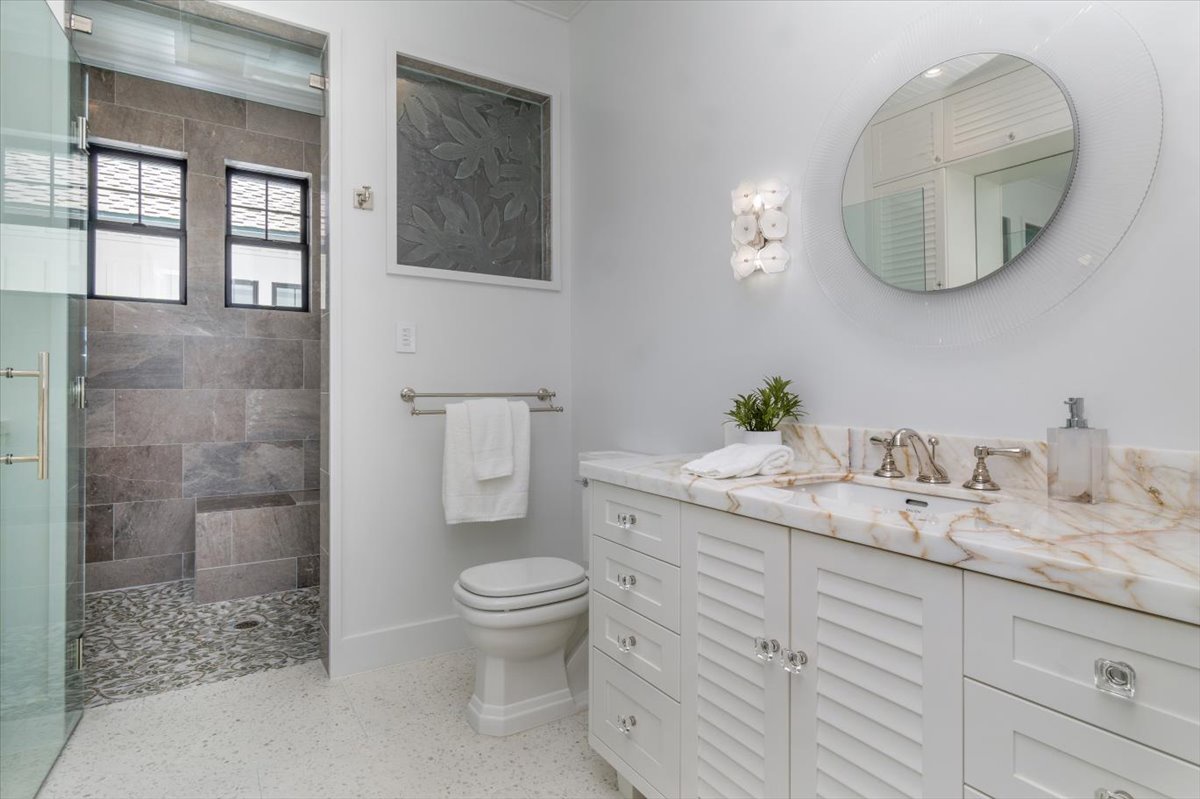 Kailua Vacation Rentals, Kailua Beachfront Estate - Beachy-modern bathroom with marble counters and walk-in shower.