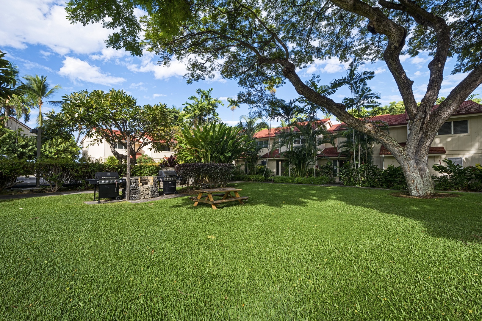 Kailua Kona Vacation Rentals, Keauhou Kona Surf & Racquet 2101 - Enjoy a serene picnic surrounded by lush greenery in our beautifully manicured grass front.