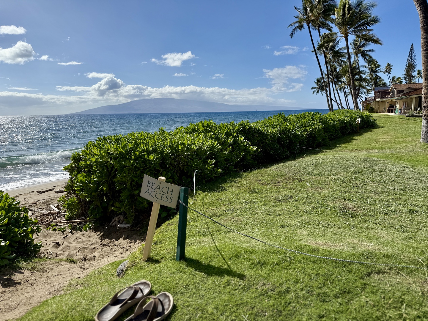 Lahaina Vacation Rentals, Puamana 254-2 - Oceanfront home with a ‘Beach Access’ sign, guiding you to the shore.