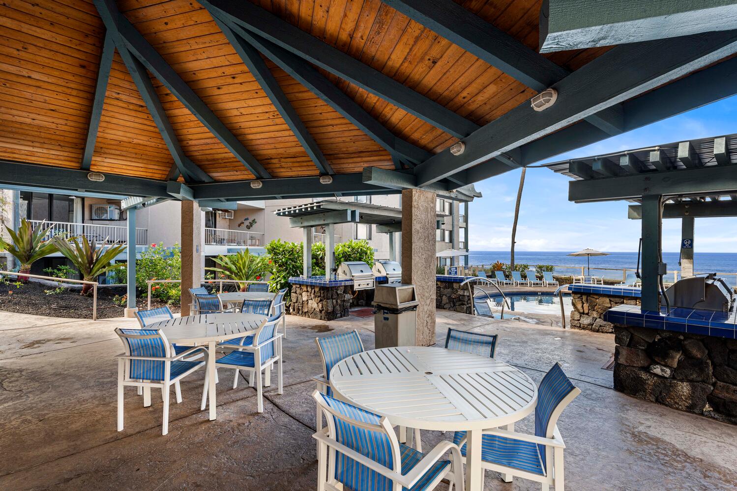 Kailua Kona Vacation Rentals, Kona Reef F23 - Alfresco dining with an oceanfront view by the pool at the community area.