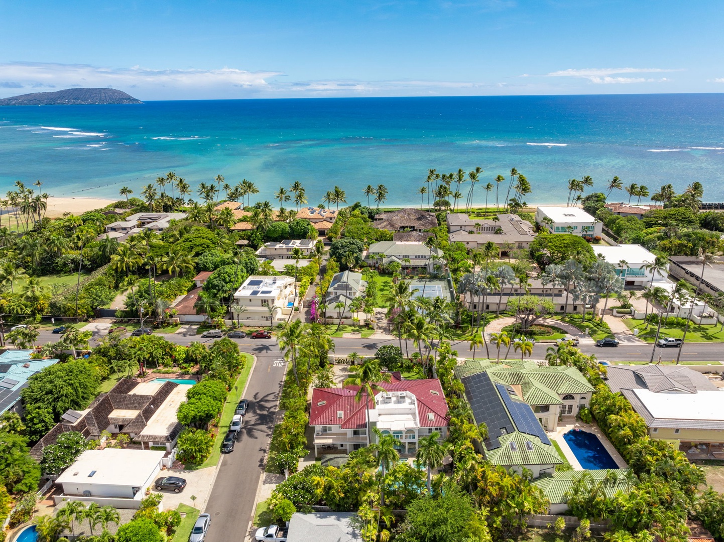 Honolulu Vacation Rentals, Kahala Oasis - Aerial view capturing the coastal neighborhood and beach, emphasizing the villa’s proximity to the ocean.