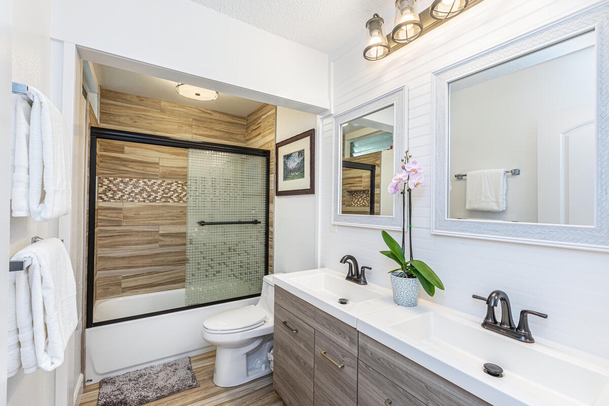 Princeville Vacation Rentals, Hale Hana Mana’o - Get ready in this stylish bathroom featuring dual vanities and a spa-inspired shower.