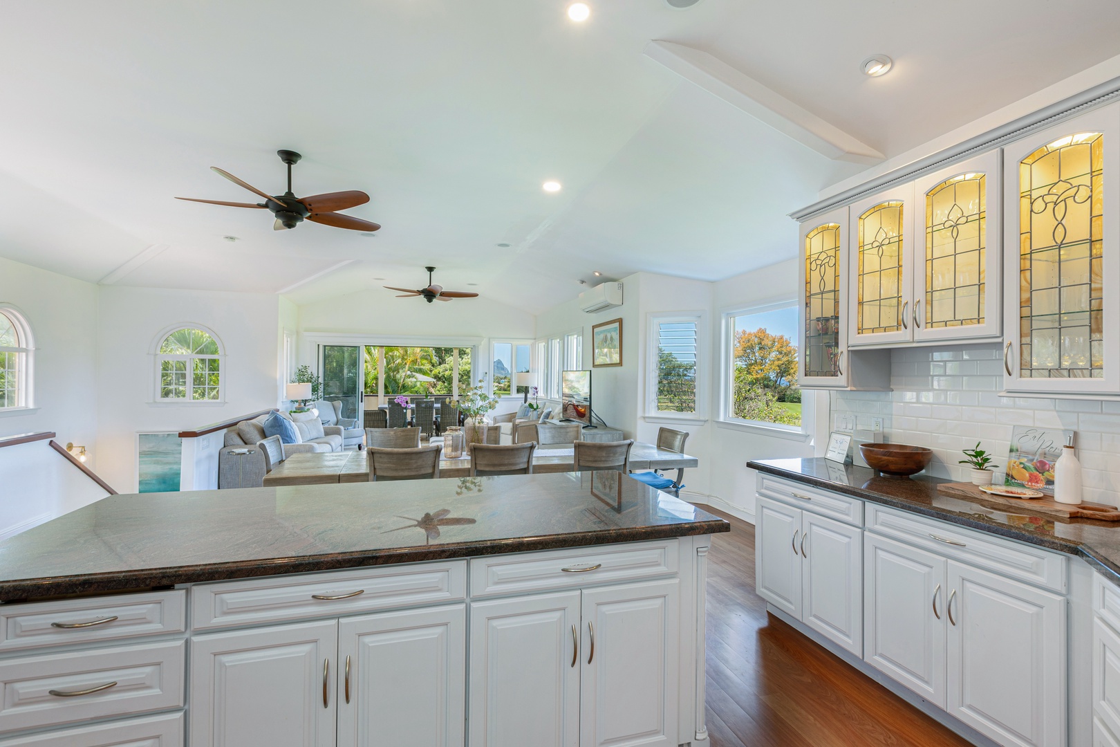 Princeville Vacation Rentals, Ohana Kamalani - Open kitchen layout with sleek counters and island seating, ideal for preparing group meals and entertaining.