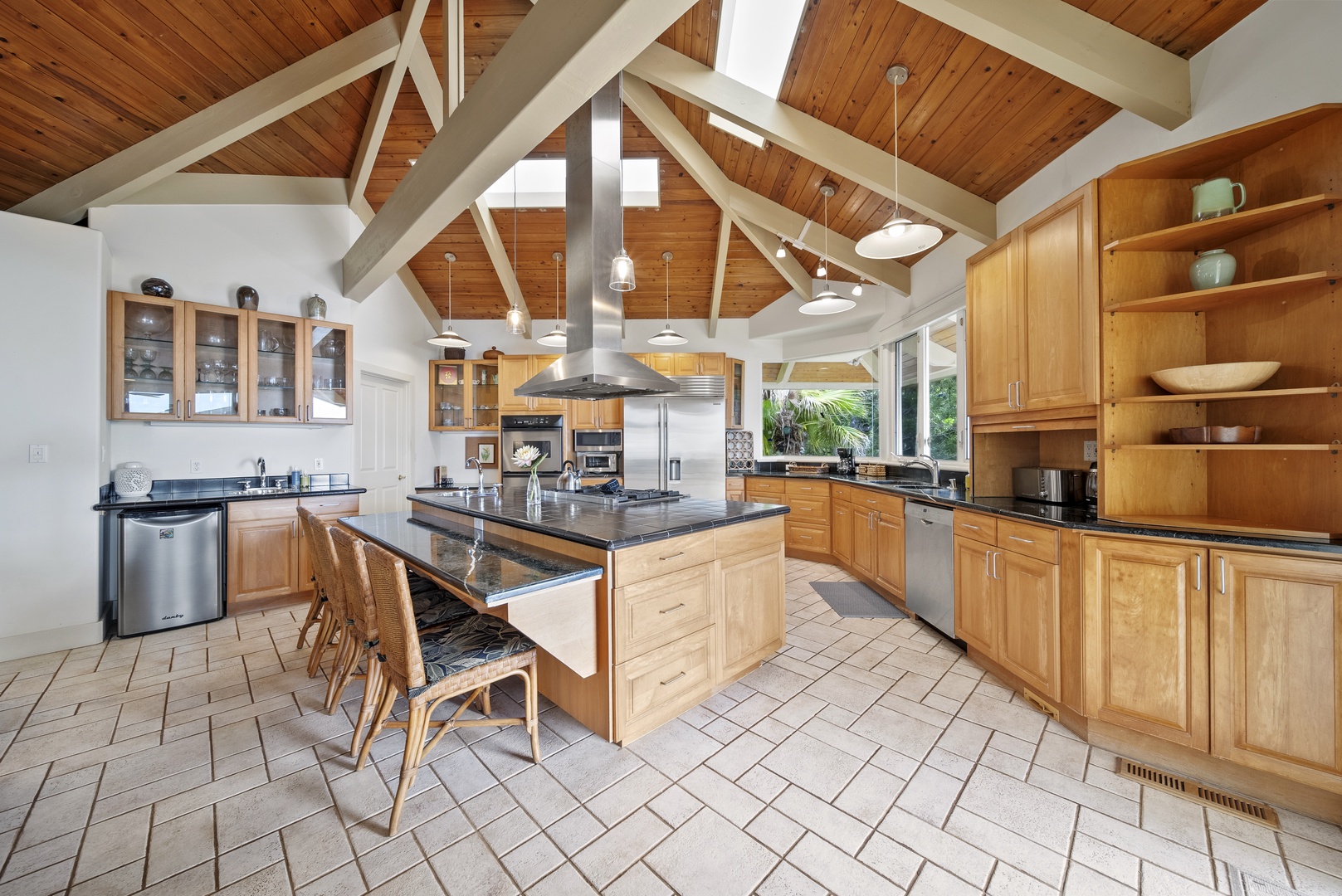 Haleiwa Vacation Rentals, Ka Hale Hau'oli - The spacious gourmet kitchen features vaulted wood ceilings, granite countertops, and premium appliances, perfect for creating memorable meals together.