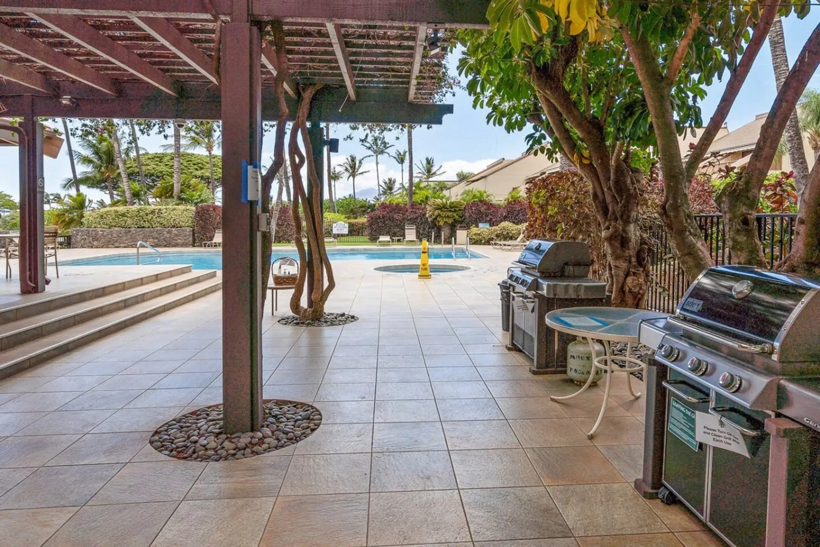 Kihei Vacation Rentals, Maui Kamaole E103 - Step down from the pergola to the pool, the jacuzzi, and the grills, all a few feet apart.