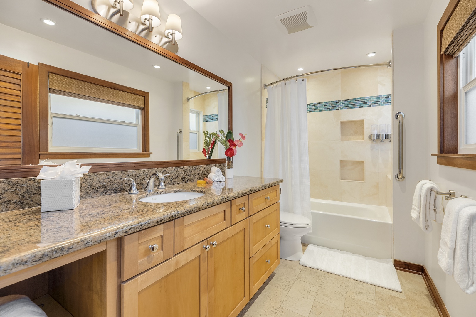 Honolulu Vacation Rentals, Hale Makai at Diamond Head - Spa-inspired primary bathroom with walk-in shower, dual vanity, and warm wood accents for a relaxing escape.