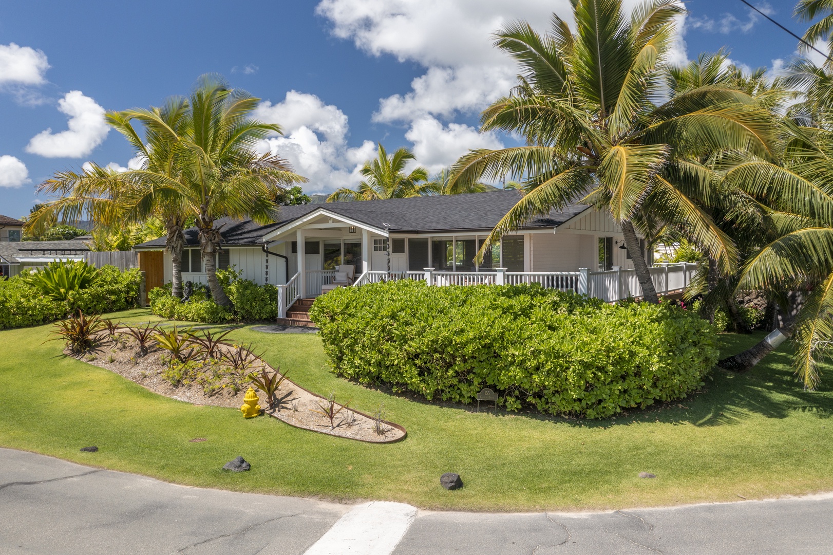 Kailua Vacation Rentals, Ranch Beach Estate - Charming home facade embraced by vibrant green foliage.