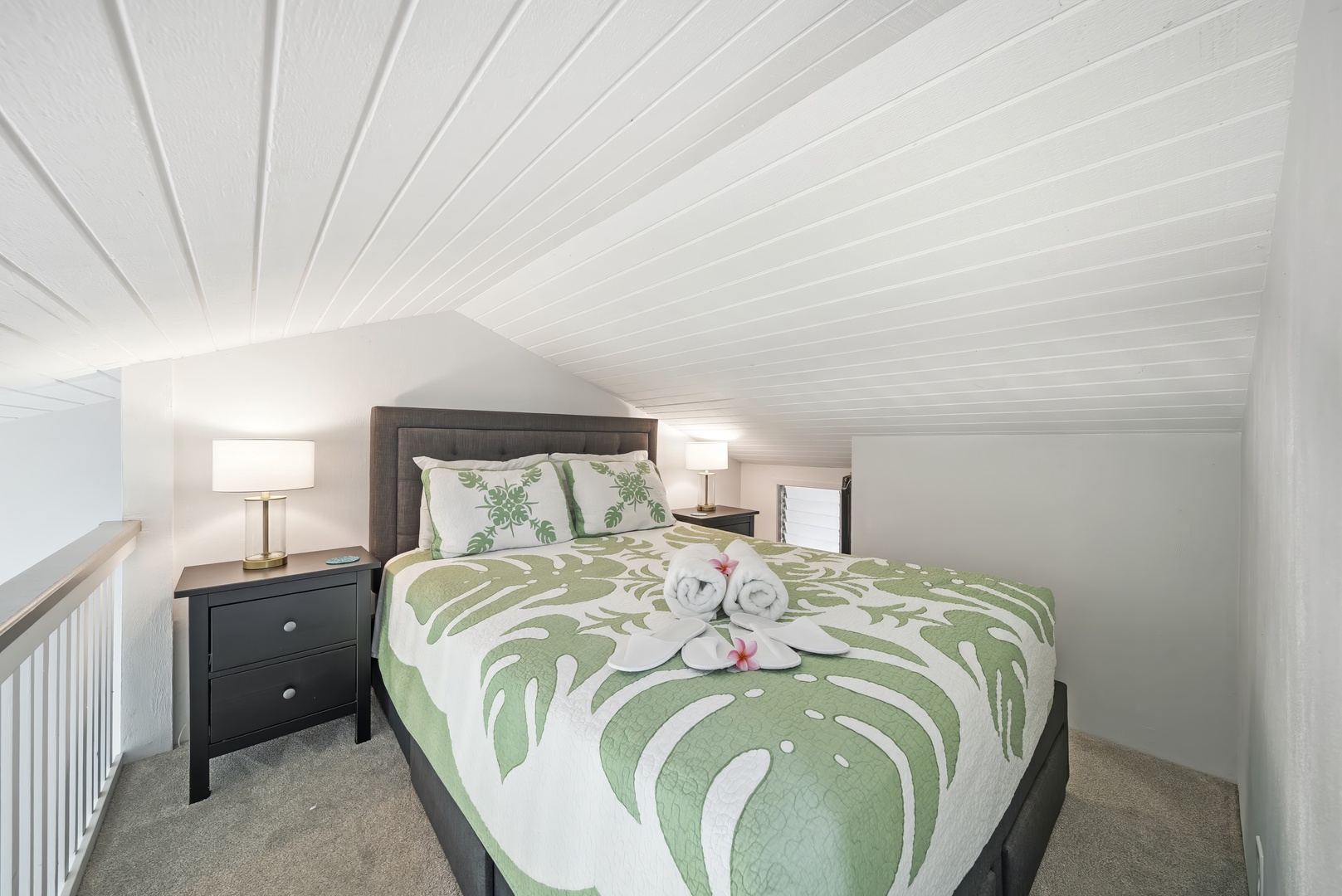Kahuku Vacation Rentals, Kuilima Estates West #132 - A queen bed dressed in island greens, nightstand and lamp ready for late reading.