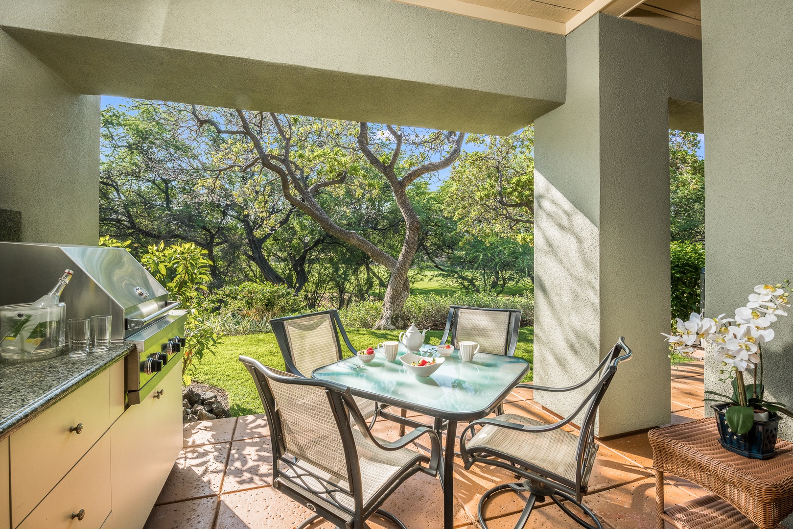 Kamuela Vacation Rentals, Mauna Lani Fairways #204 - Start your day soaking up the morning light on your private lanai, surrounded by lush trees and serene greenbelt views.