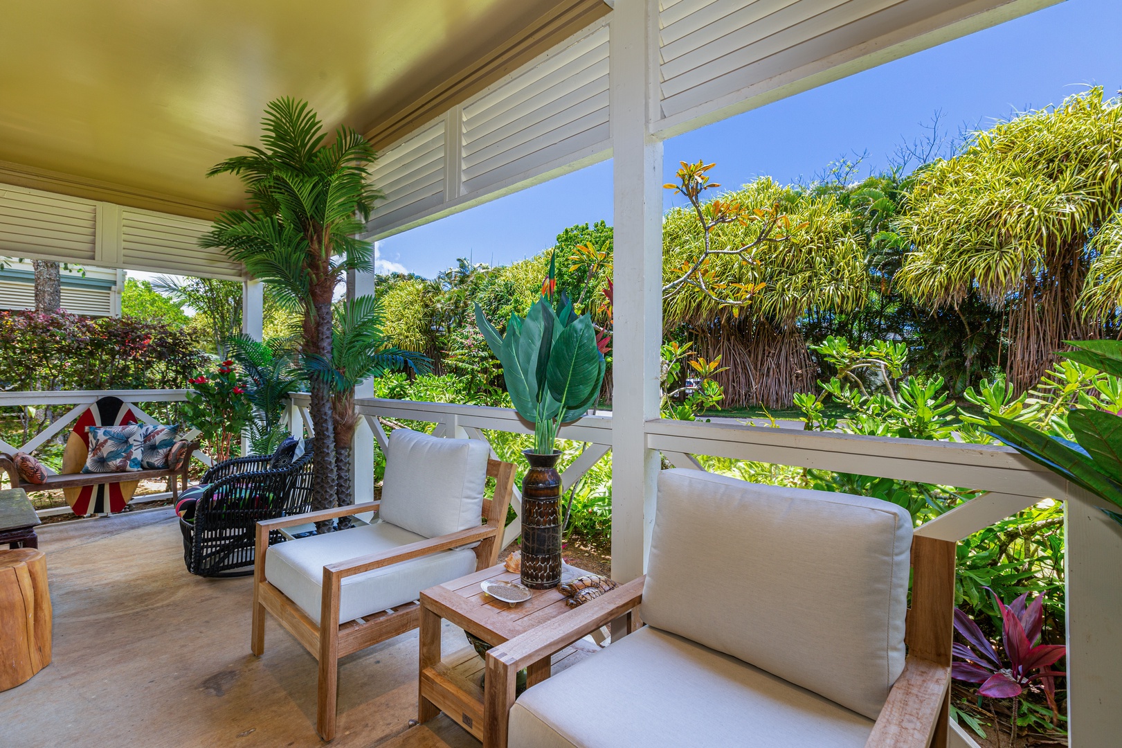 Princeville Vacation Rentals, Pualani Villa - The covered patio offers cozy outdoor seating with lush garden views.