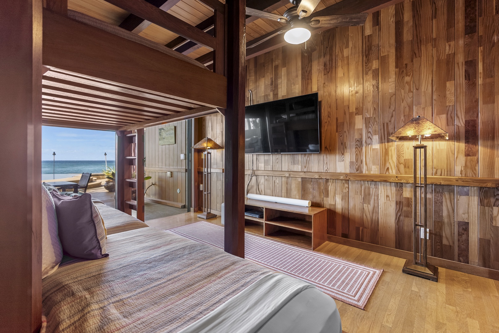 Haleiwa Vacation Rentals, Samurai House - Cozy bunk room with ocean views and a wall-mounted TV for relaxation.