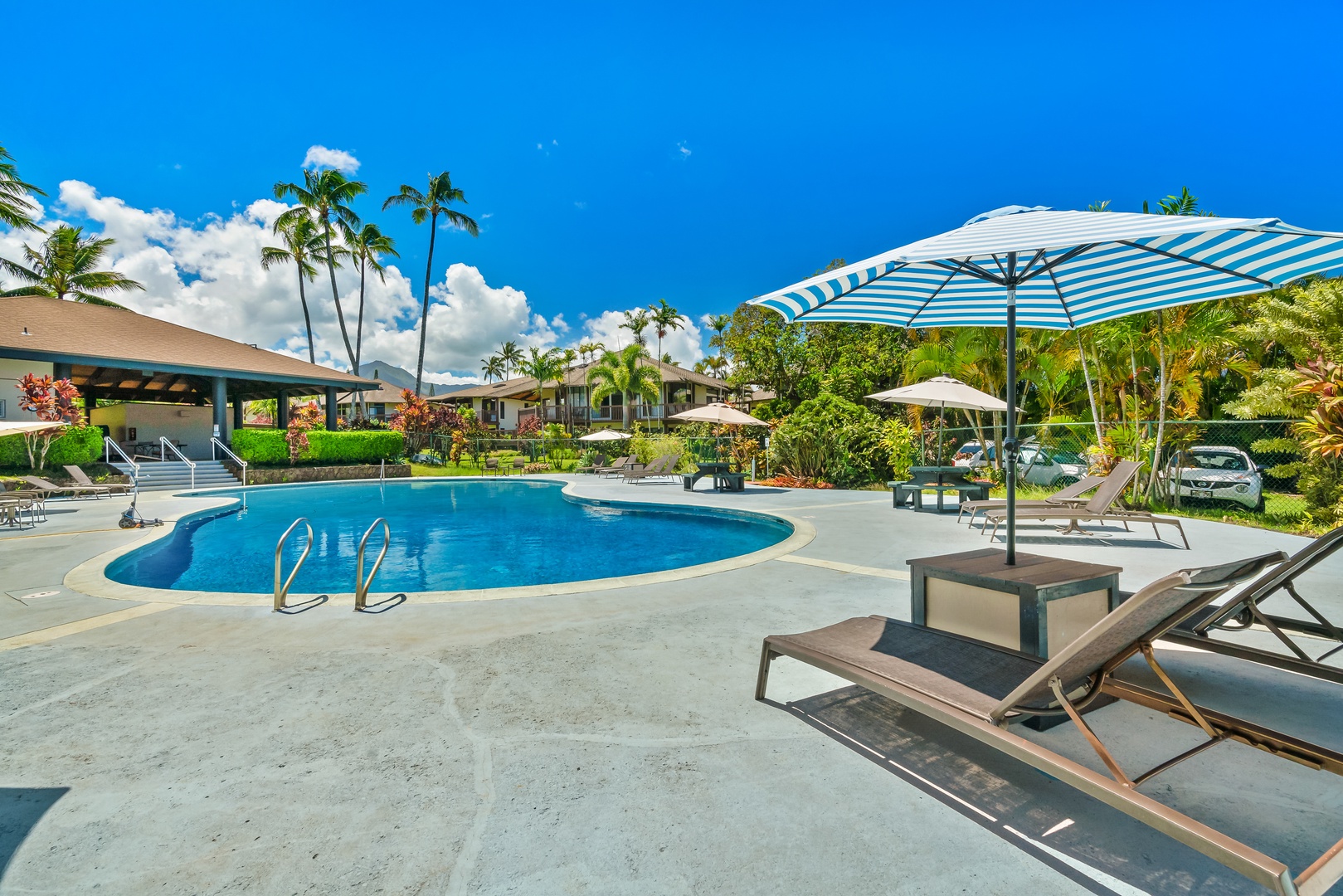 Princeville Vacation Rentals, Mauna Kai 7B - Sun and shade trade places all afternoon along the poolside.
