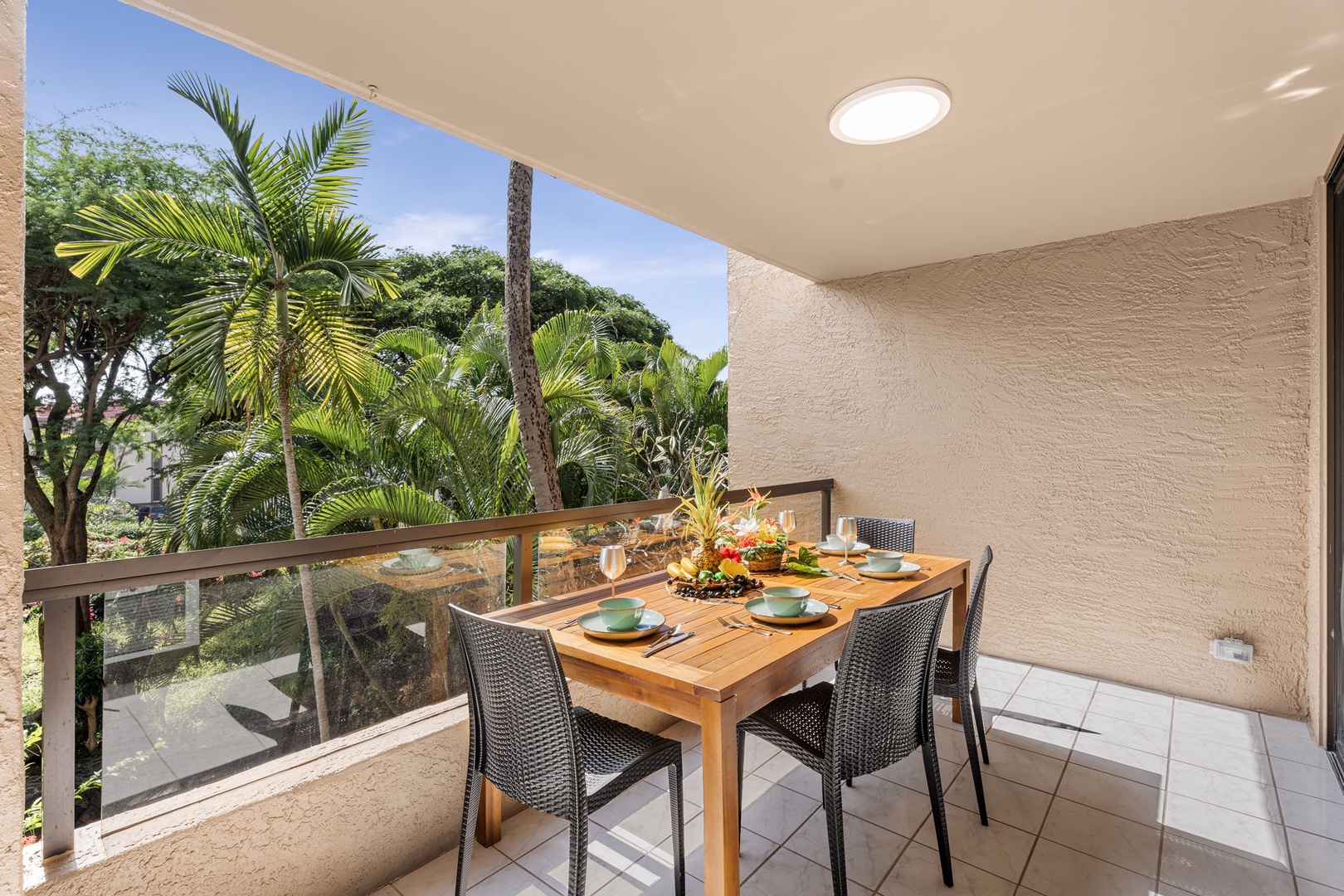 Kailua Kona Vacation Rentals, Kona Pacific C416 - Balcony dining space surrounded by lush palms and peaceful vibes.