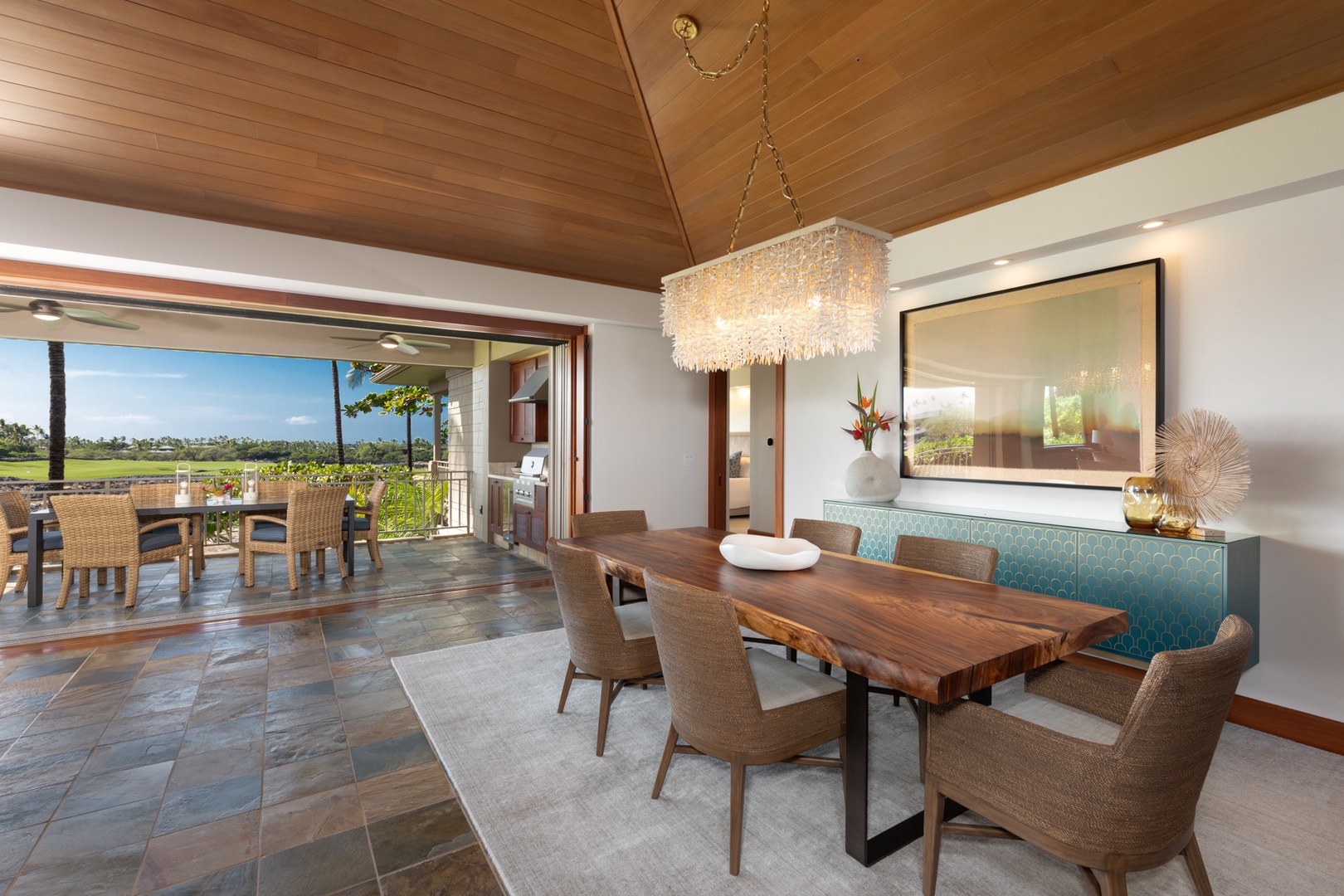 Kailua Kona Vacation Rentals, 3BD Waiulu Villa (111D) at Hualalai Resort - Elegant dining awaits with stunning views through floor-to-ceiling windows that open to your private lanai overlooking lush landscapes.