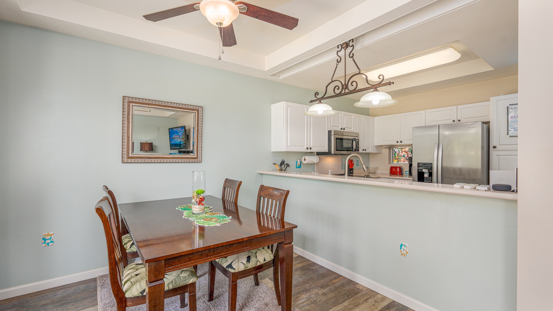 Kapolei Vacation Rentals, Fairways at Ko Olina 8G - Your open kitchen and dining space features elegant wood beams, modern appliances, and a cozy breakfast bar perfect for morning coffee.